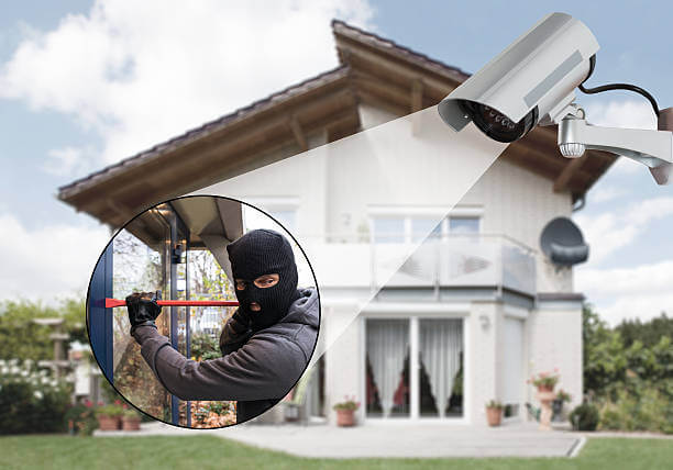 Surveillance Camera Capturing Burglar Using Crowbar To Open Glass Door