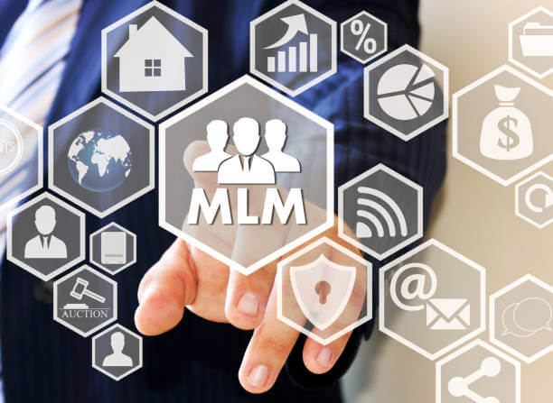 The businessman clicks the button MLM on the touch screen . The concept of multi-level marketing.