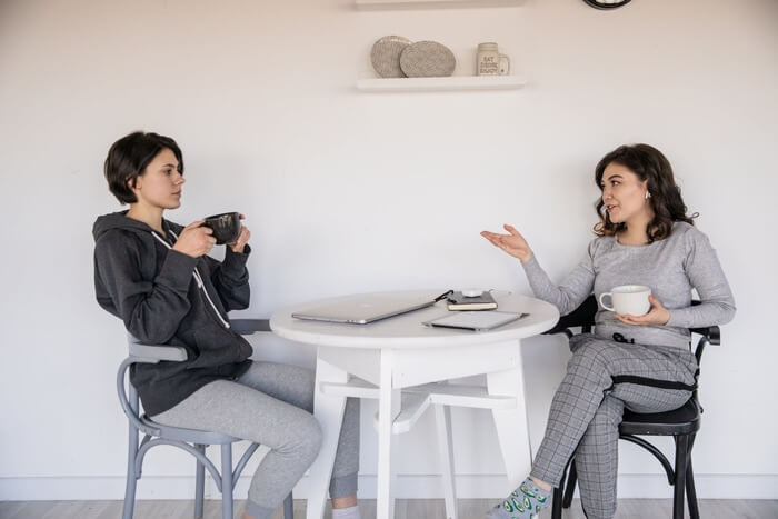 two woman talking over coffee